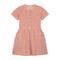 The Yuki kidswear Terry Dress Anna in Blossom Pink features short sleeves, front buttons, two large front pockets with a small YOU logo, a gathered waist, and is made from soft organic cotton for all-day comfort.