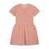 The Yuki kidswear Terry Dress Anna in Blossom Pink features short sleeves, front buttons, two large front pockets with a small YOU logo, a gathered waist, and is made from soft organic cotton for all-day comfort.