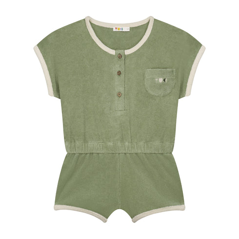 The Yuki kidswear Terry Playsuit Billie - SAGE (PO) is a short-sleeve sage green outfit with a front chest pocket, three front buttons, white trim on sleeves, neckline and legs, plus an elastic waistband for easy summer style.