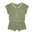 The Yuki kidswear Terry Playsuit Billie - SAGE (PO) is a short-sleeve sage green outfit with a front chest pocket, three front buttons, white trim on sleeves, neckline and legs, plus an elastic waistband for easy summer style.